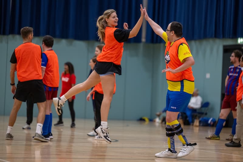 Two netball players giving a high five