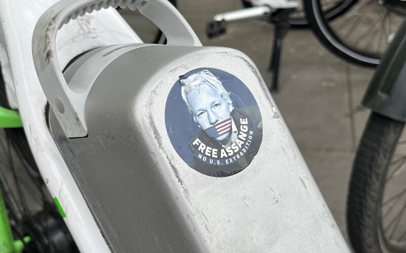 A free Julian Assange sticker on a bike in London.