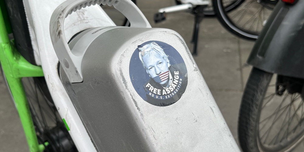 A free Julian Assange sticker on a bike in London.
