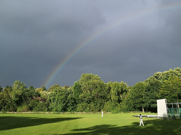 Rainbow appears during a cricket game