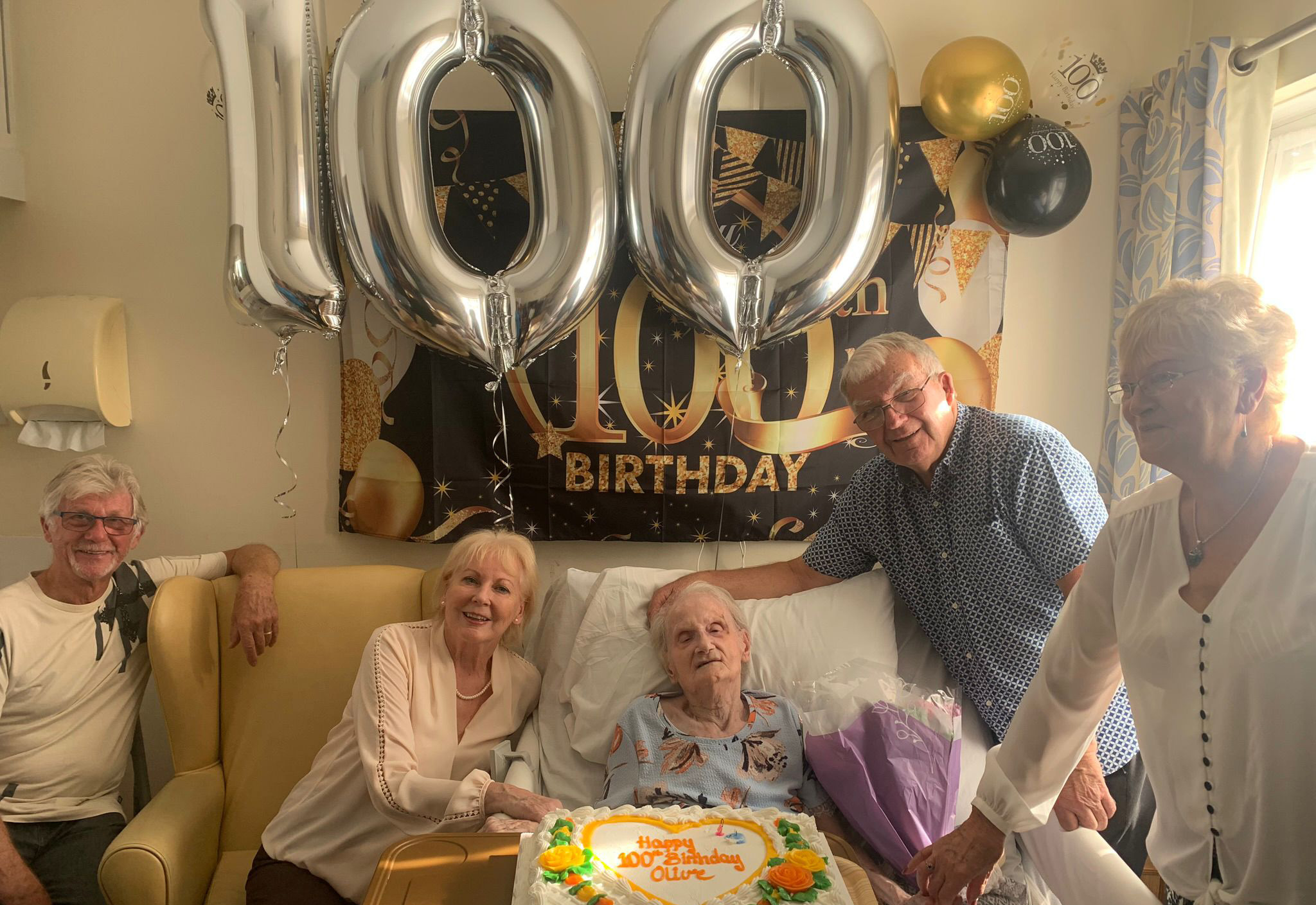 Olive Masters celebrating with members of her family