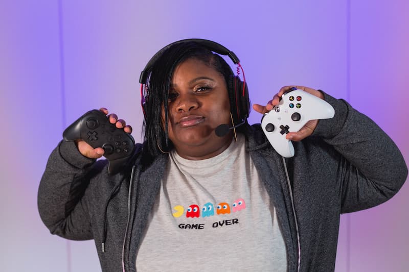Mikayla Jones holding two video game controllers