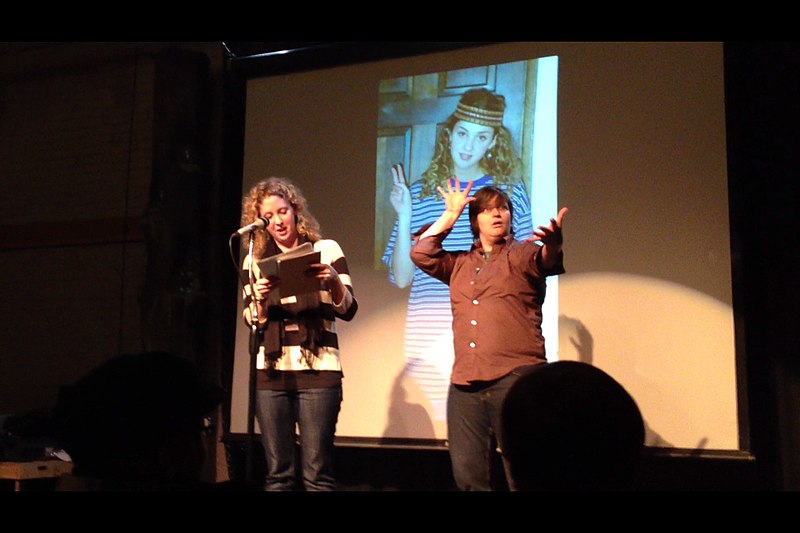A poetry reading with a sign language interpreter.