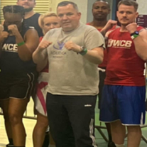 Head coach of Boudica boxing John Ryan with volunteer boxers.