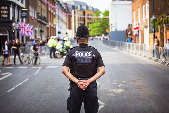 A picture of a police officer standing in a street.