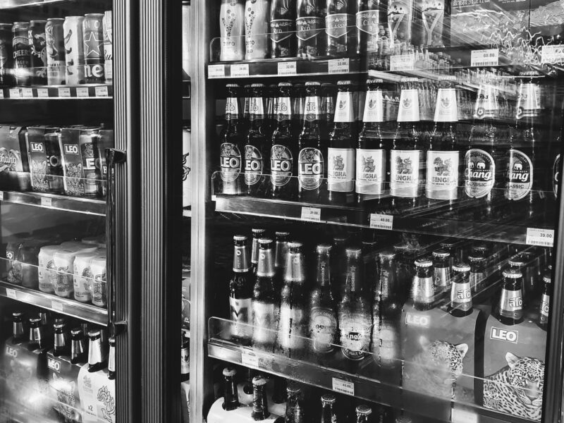 Black and white image of a fridge containing alcohol